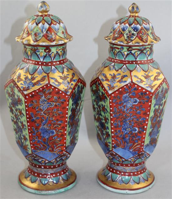 A pair of Chinese hexagonal baluster clobbered vases and covers, 18th century and later, 31.5cm